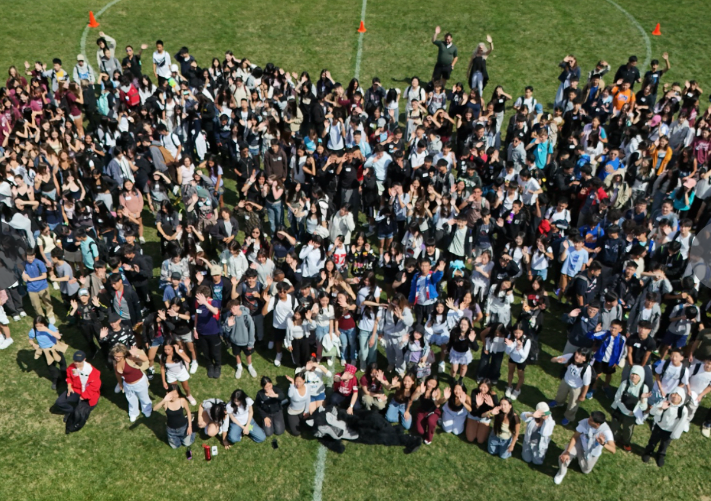 crowd of students standing on field