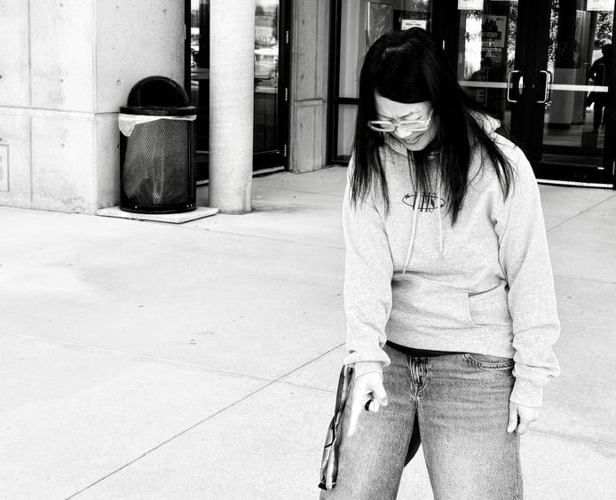 Black and white photo of woman point finger downwards