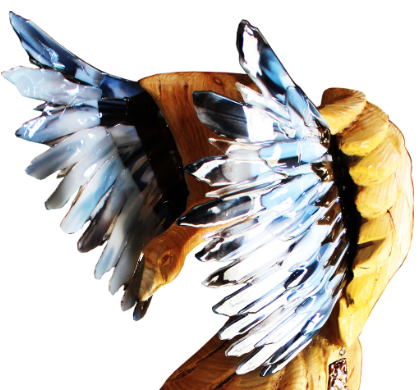 wooden curved sculpture with glass looking wings extending from it