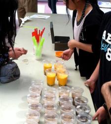 Students working behind a desk at a food sale competition