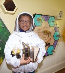 A person standing in front of the interactive honeycombs.