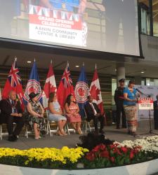 A group of people presenting on a stage during the grand opening celebration of the Aaniin Community Centre and Library.