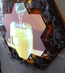 A honeycomb displaying a video about honey.